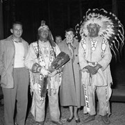 Cover image of 3 unknown people and Tom Kaquitts (Sûga Wakâ) (Dog God) (right)